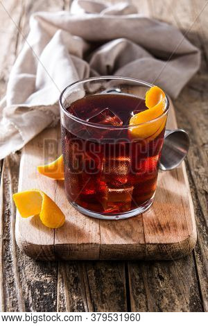 Boulevardier Cocktail And Orange Zest On Wooden Table