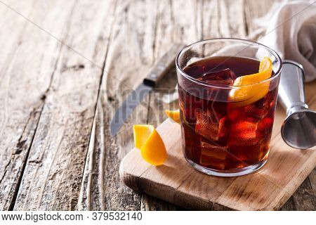 Boulevardier Cocktail And Orange Zest On Wooden Table. Copy Space