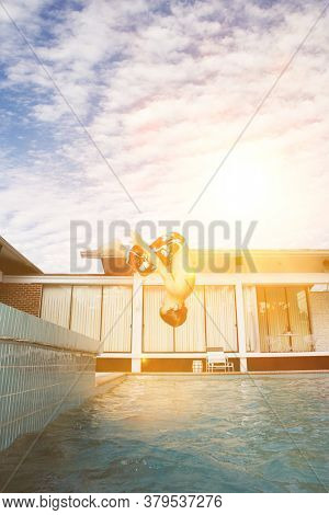 Little boy doing summersaults into the swimming pool