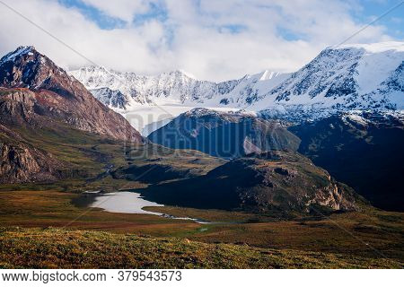 Awesome Picturesque View To Mountain Range In Sunny Day. Beautiful Green Highland Relief With Glacie