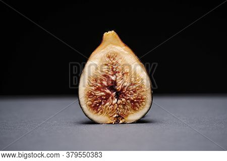 Fig Split In Half On A Grey Surface On A Black Background
