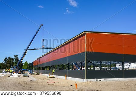 Truck Mounted Crane With A Telescoping Boom At Constructing A Metal Carcas Of A New Building