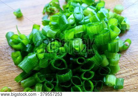 Green Chopped Onion On A Board Close-up Blurred Background