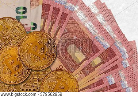 10 Euro Bills And Golden Bitcoins. Cryptocurrency Investment Concept. Crypto Mining Or Trading
