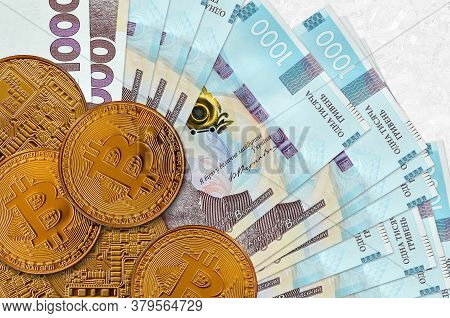1000 Ukrainian Hryvnias Bills And Golden Bitcoins. Cryptocurrency Investment Concept. Crypto Mining 