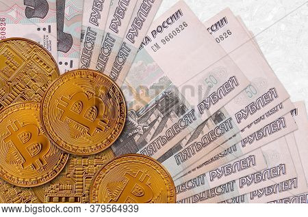 50 Russian Rubles Bills And Golden Bitcoins. Cryptocurrency Investment Concept. Crypto Mining Or Tra