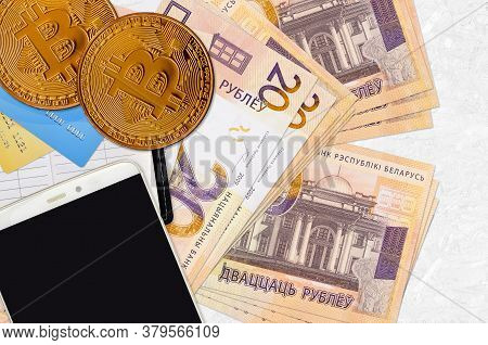 20 Belorussian Rubles Bills And Golden Bitcoins With Smartphone And Credit Cards. Cryptocurrency Inv