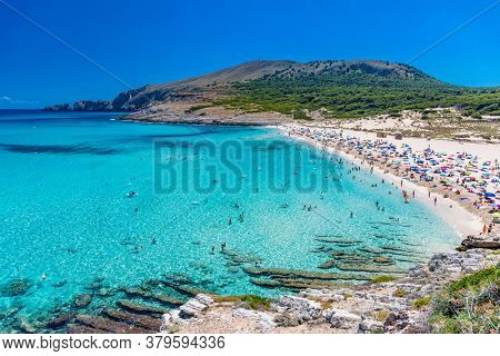 CALA MESQUIDA, MALLORCA, SPAIN - 19 July 2020: People enjoying beautiful sandy beach of on Mallorca, Mediterranean Sea, Balearic islands, Spain.