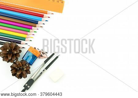 Multi-colored Pencils, Eraser, Ruler, Sharpener And Compasses On A White Background.