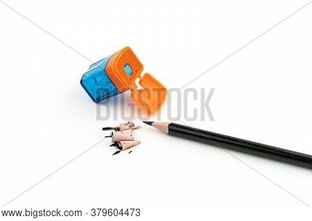 Pencil And Sharpener With Rubbish From Pencil On White Background