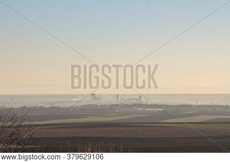 Panorama Of The City Of Sid, Seen Frol Above, During A Foggy Dusk, In Winter, Surrounded By Agricult
