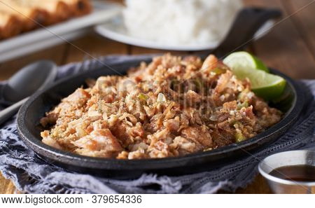filipino food - pork sisig in cast iron pan