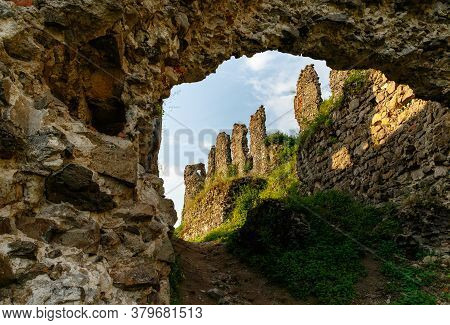 Ruins Of Old Hungarian Castle At Sunset  In Khust City, Western Ukraine.