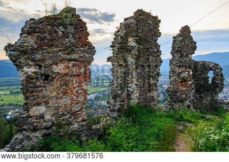 Ruins Of Old Hungarian Castle At Sunset  In Khust City, Western Ukraine.