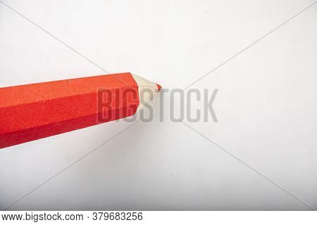 Red Pencil Stands On A White Background.