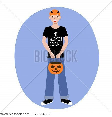Red Haired Boy In A T Shirt With The Words My Halloween Costume And Horns On His Head. Pumpkin Candy