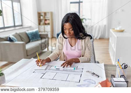 architecture, building, construction and real estate concept - african american female architect with blueprint, ruler and living house model on table working at home office