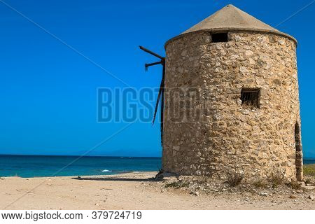 The Old Windmill Is Located On Gira Beach, Lefkada Island, Greece