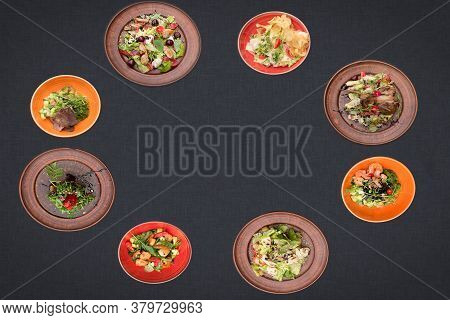 Many Salads On A Black Background Lie In A Circle With Sopy Space