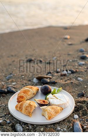 Vertical Image Of The Beach Picnic With Figs, Croissants And Camamber Cheese. Negative Space.