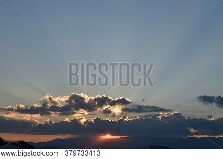 Sunset With Lights Crossing The Clouds In Sky