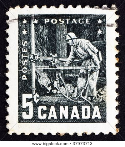 CANADA - CIRCA 1957: a stamp printed in the Canada shows Miner with Pneumatic Drill, 6th Commonwealth Mining and Metallurgical Congress, Vancouver, circa 1957