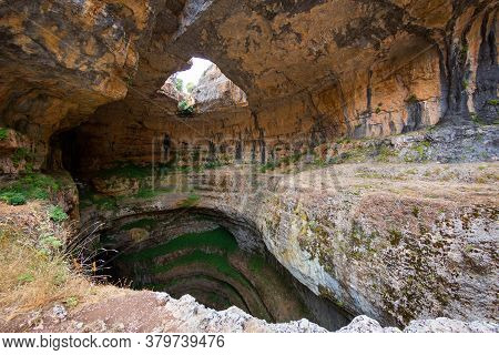 Baatara Gorge Waterfall In Lebanon. Balaa Sinkhole Caves And Formations Covered With Green Plants. N