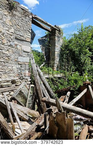Destroyed House With Broken Walls And Old Wooden Planks After The Terrible Earthquake