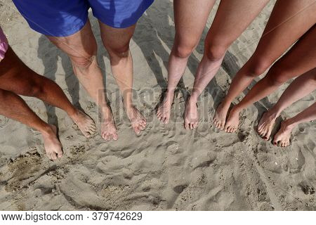 Ten Feet Of A Family Of Five On The Sandy Beach In Summer