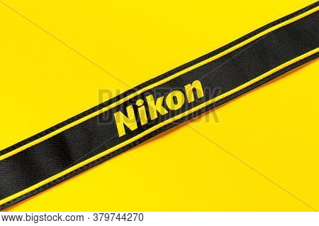 Moscow, Russia - July 15, 2020: Strap From Camera Nikon On Yellow Background Flat Lay. Digital Photo