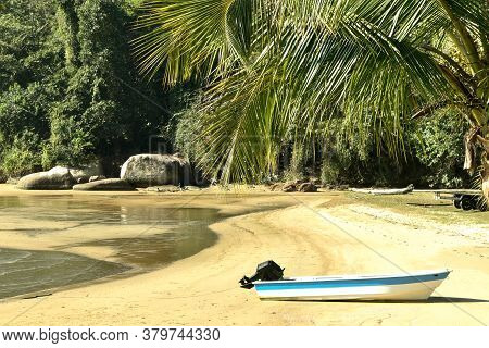 Small Boat On The Beach Sand In Sunny Day