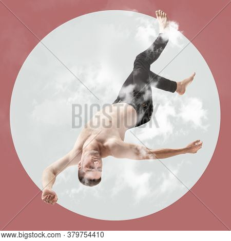 Mid-air Beauty Cought In Moment. Full Length Shot Of Young Man Hovering In Air And Keeping Eyes Clos