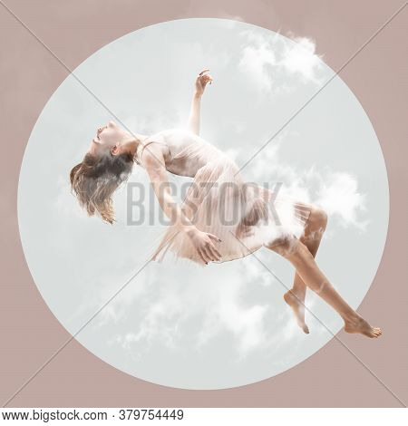 Mid-air Beauty Cought In Clouds. Full Length Shot Of Attractive Young Woman Hovering In Air And Keep