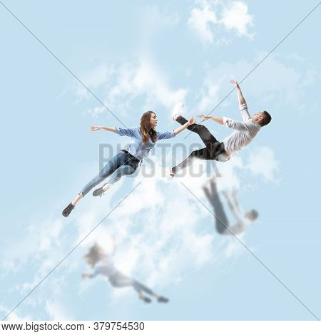 Mid-air Beauty Cought In Sky. Full Length Shot Of Attractive Young Woman And Man Hovering In Air And