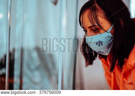 Close Up Of Young Woman In Medical Mask Considers Exhibits In Museum. Female Tourist At Exhibition I