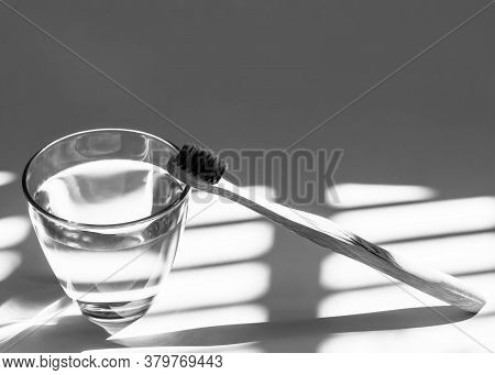 Bamboo Toothbrush, Glass Of Water And Toothpaste Powder In Black And White. Biodegradable Pesonal Ca