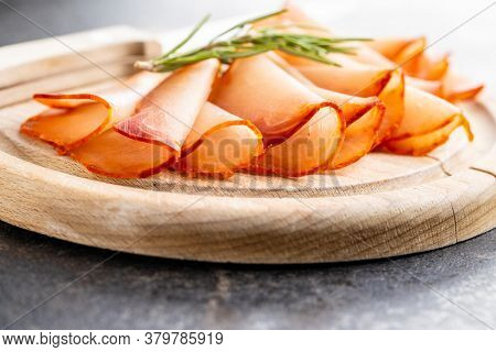 Dried spanish ham. Lomo embuchado on cutting board.