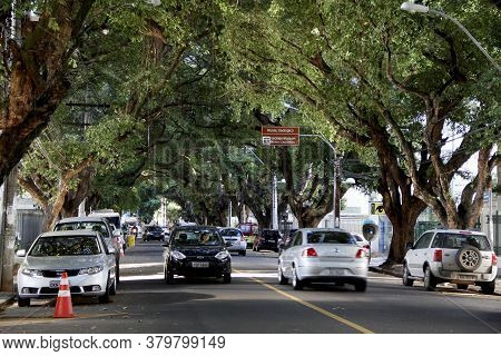 Salvador, Bahia / Brazil - March 23, 2013: Vehicles Are Seen On A Tree-lined Street In The Corredor 