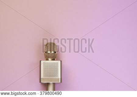Gold Karaoke Microphone On Pink Background, Top View. Karaoke Microphone Recording Concept A Microph