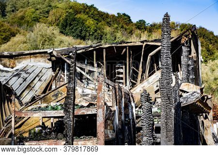 Close Up Damaged Supermarket Glass Plastic Bottles On Shelves After Arson Fire With Burn Black Dark 