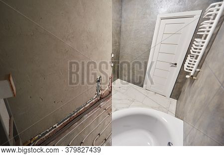 Modern Bathroom With Marble Floor And White Door Before And After Refurbishment. Comparison Of Old R