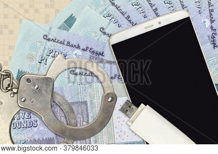 5 Egyptian Pounds Bills And Smartphone With Police Handcuffs. Concept Of Hackers Phishing Attacks, I