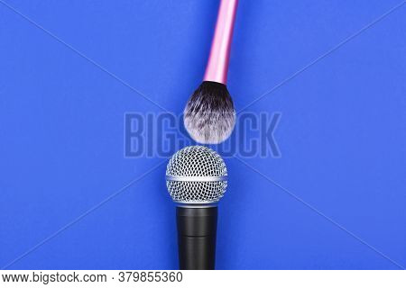 A Microphone With A Makeup Brush On Vivid Blue Background.