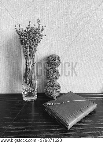 A Glass Vase With Lavender And Decorative Balls Favorably Emphasizes The Leather Surface Of The Diar