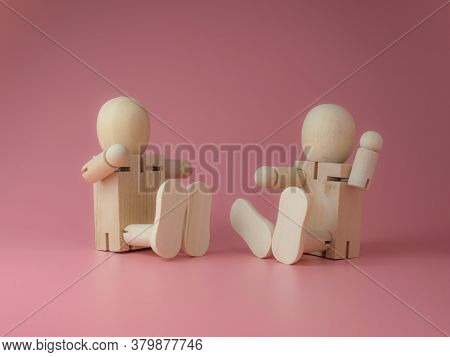 Wooden Doll Sitting And Talking Gestures On A Pink Background.
Concept Of Social Contact From Wooden