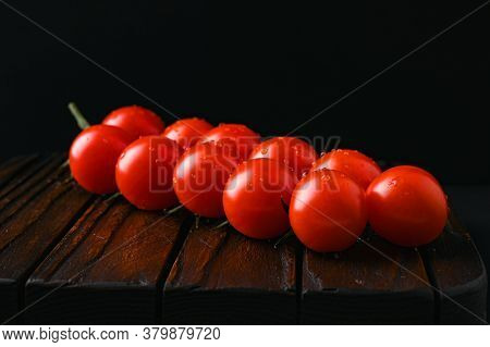 Red Tomatoes With Water Droplets On A Dark Background