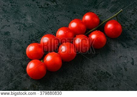 Red Tomatoes With Water Droplets On A Dark Background