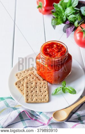 Balkan Traditional Dish Ajvar, Lutenitza, Pingjur, With Bread On A Plate On White Wooden Table