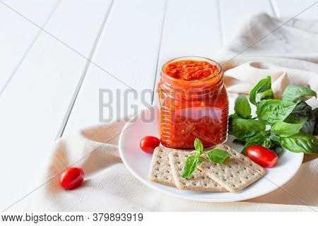 Balkan Traditional Dish Ajvar, Lutenitza, Pingjur, With Bread On A Plate On White Wooden Table. Serb