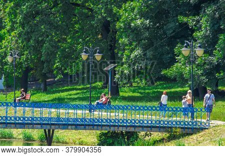 Ukraine, Kalush, August 2020: Landscape Of The City Park. People Relax Walking On A Sunday Summer Da